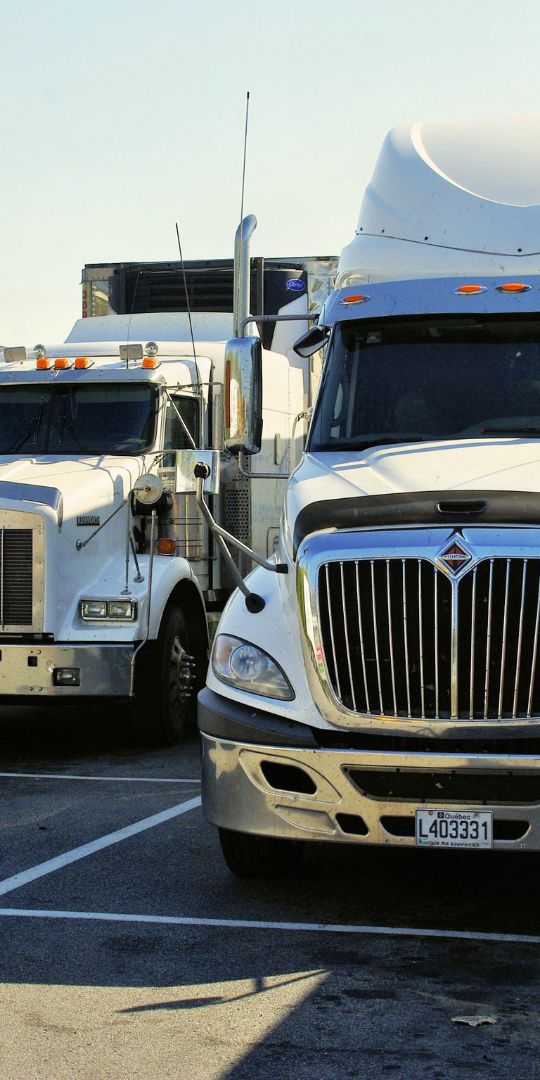 Semi trucks parked side by side
