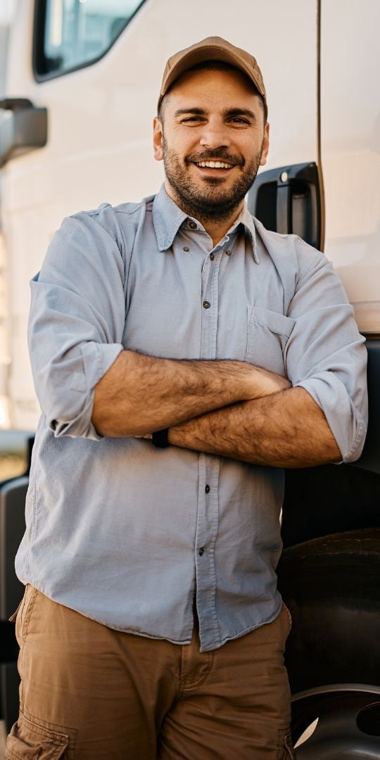 Truck driver standing in front of his rig