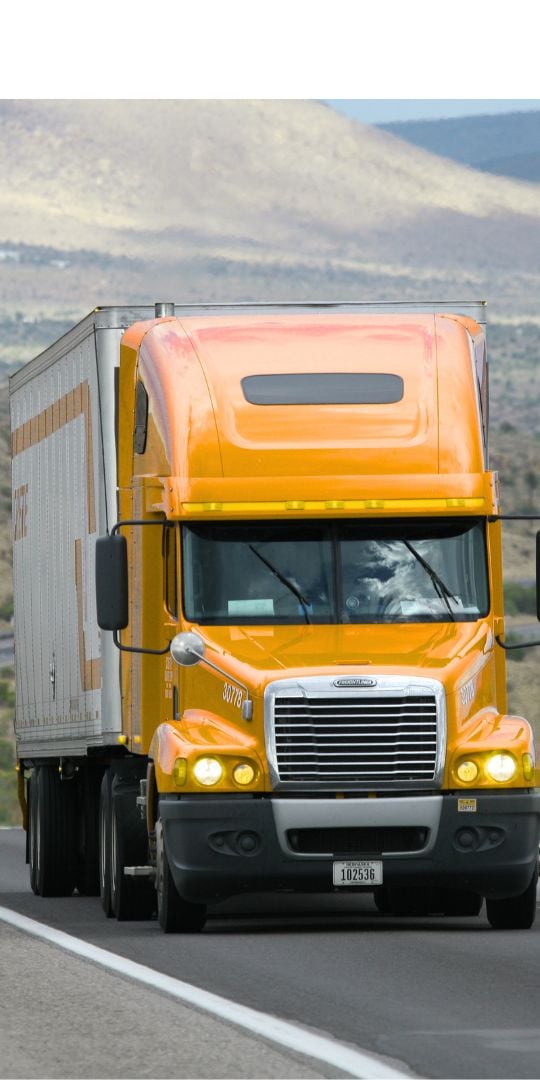 Semi truck pulling a dry van trailer on the highway