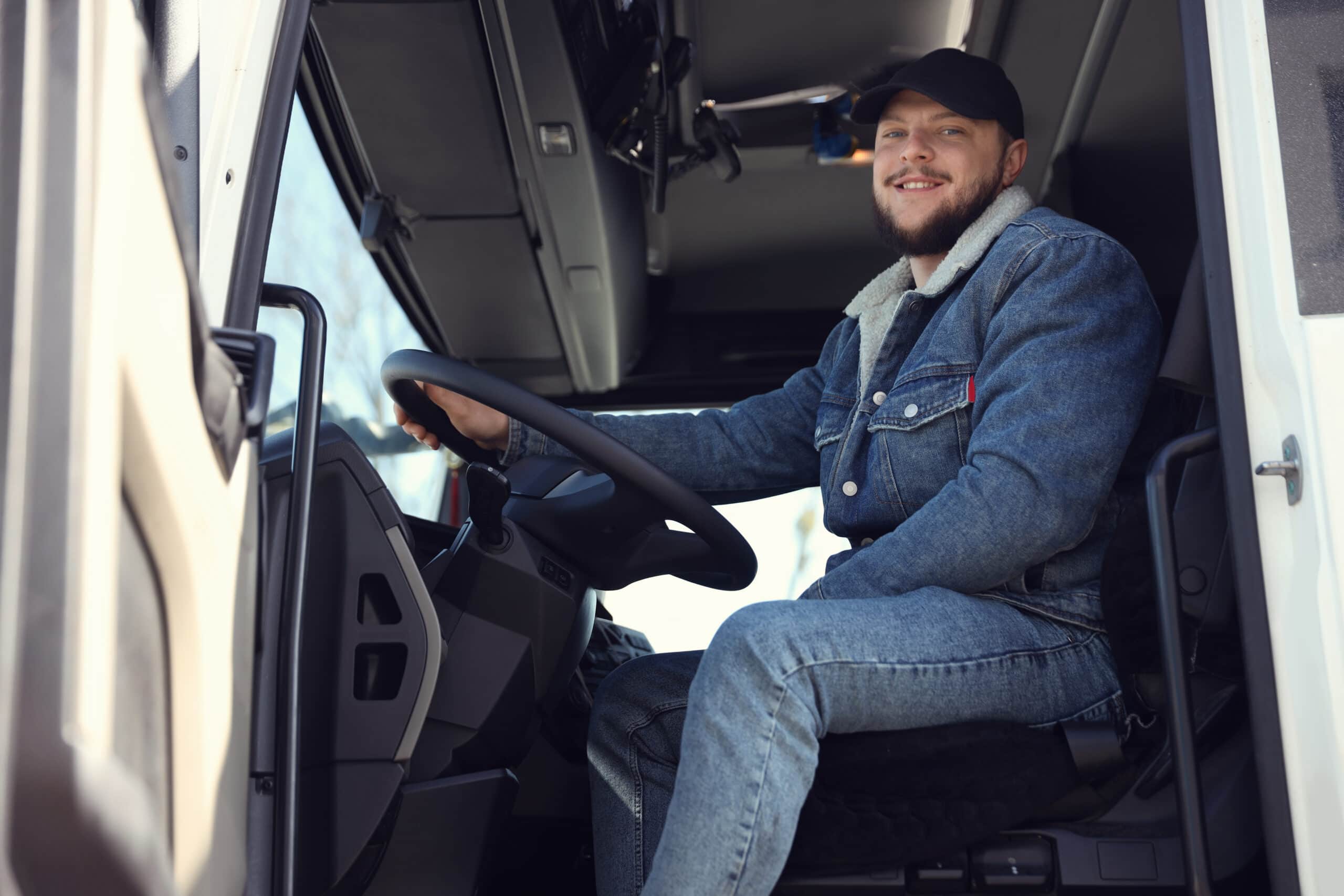 Driver smiling at the wheel of a modern truck